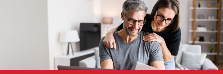Man and woman with glasses looking at paperwork