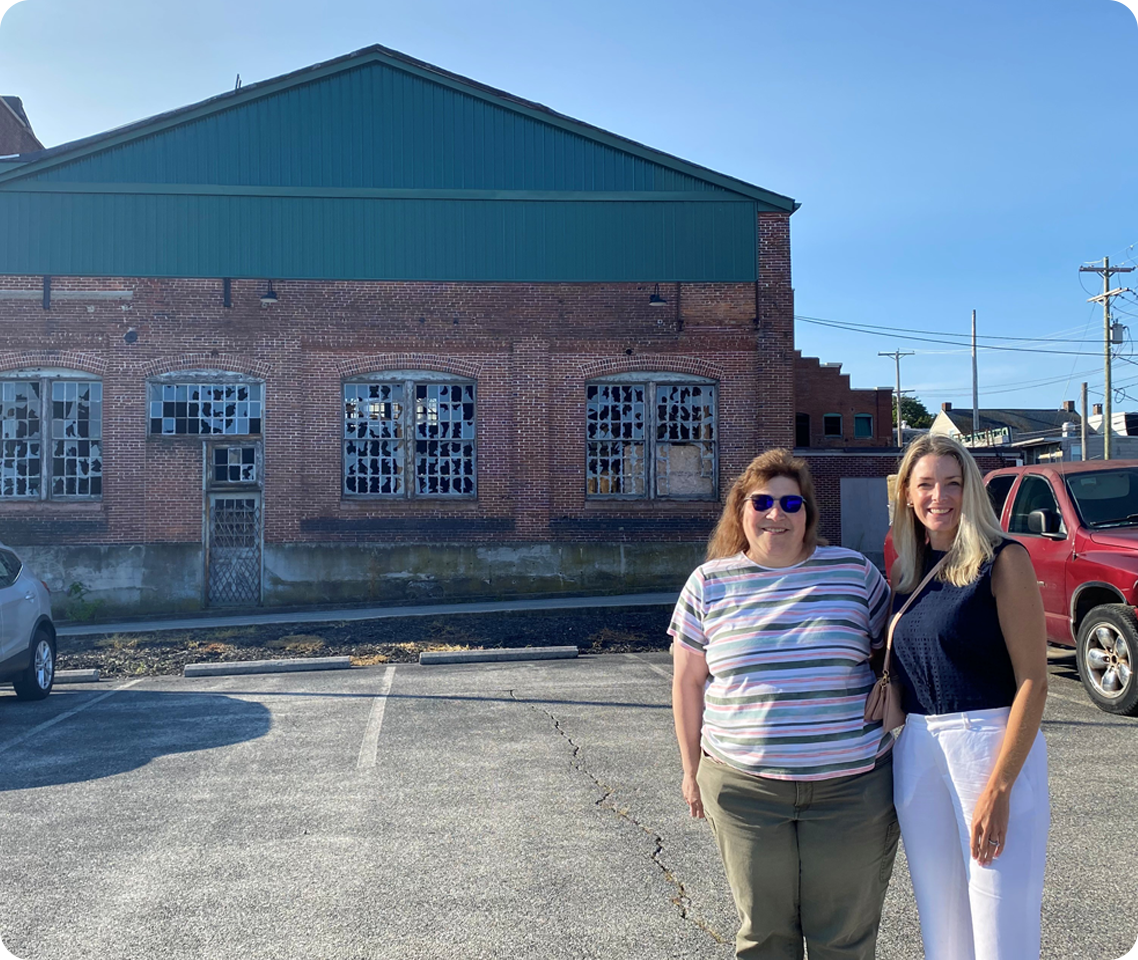 Liz and Susan standing in front of industrial building
