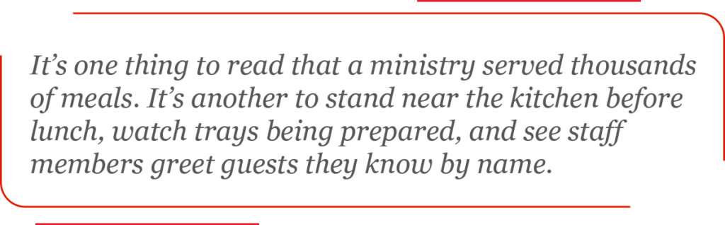 It’s one thing to read that a ministry served thousands of meals. It’s another to stand near the kitchen before lunch, watch trays being prepared, and see staff members greet guests they know by name.